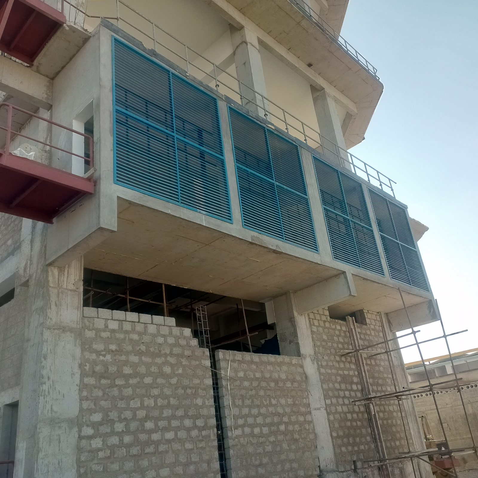 Building under construction with louver installation