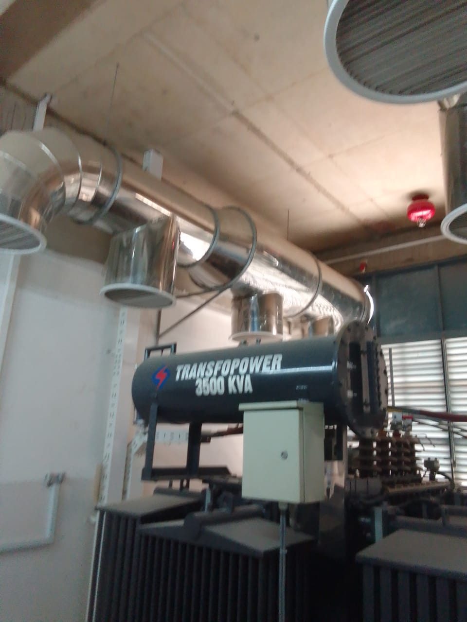 Forced-air ventilation ducting installed above a power transformer